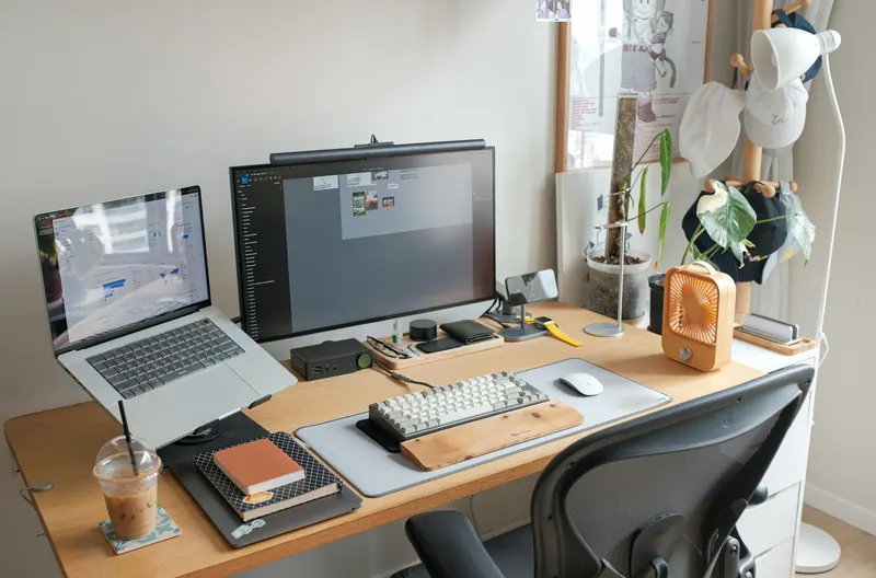 Laptop and desktop computer set up on an office desk